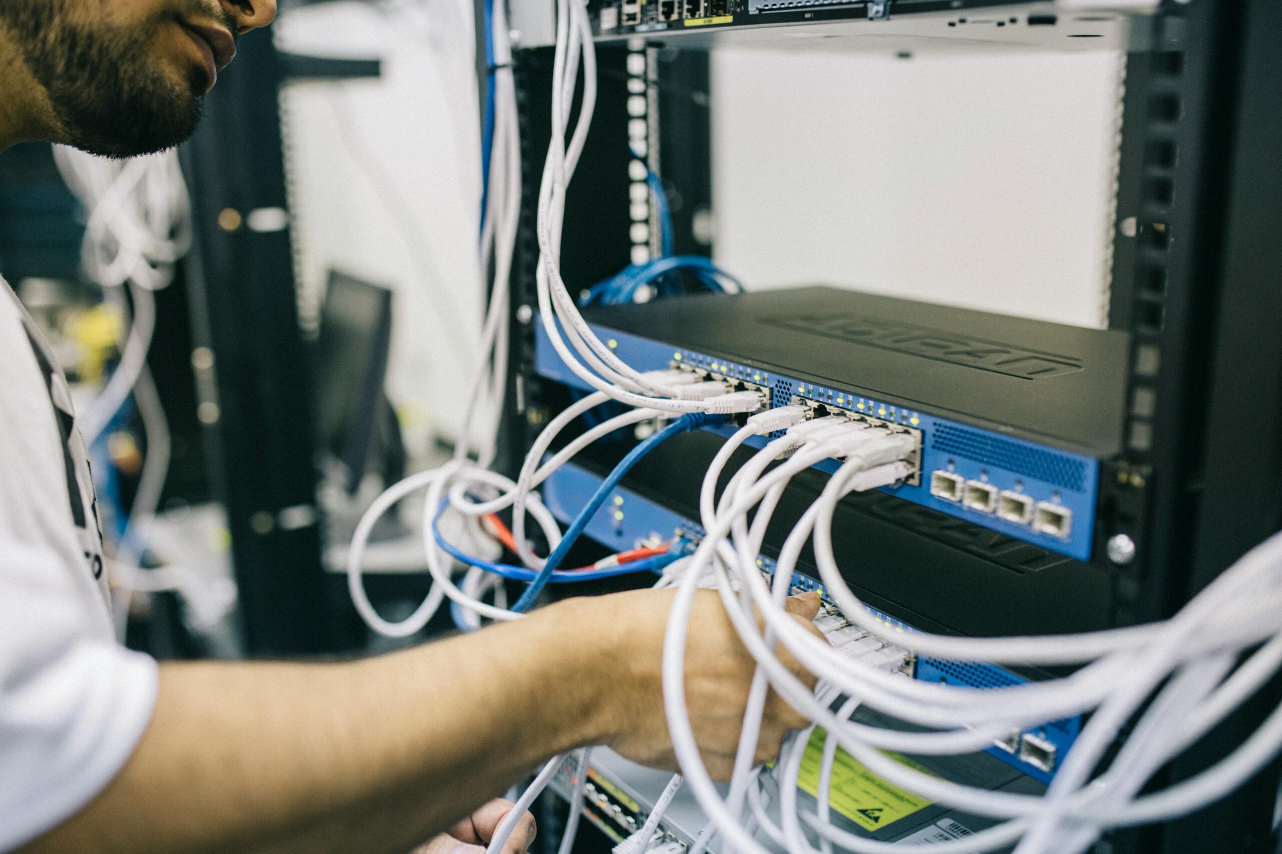 Low-voltage technician working on network equipment